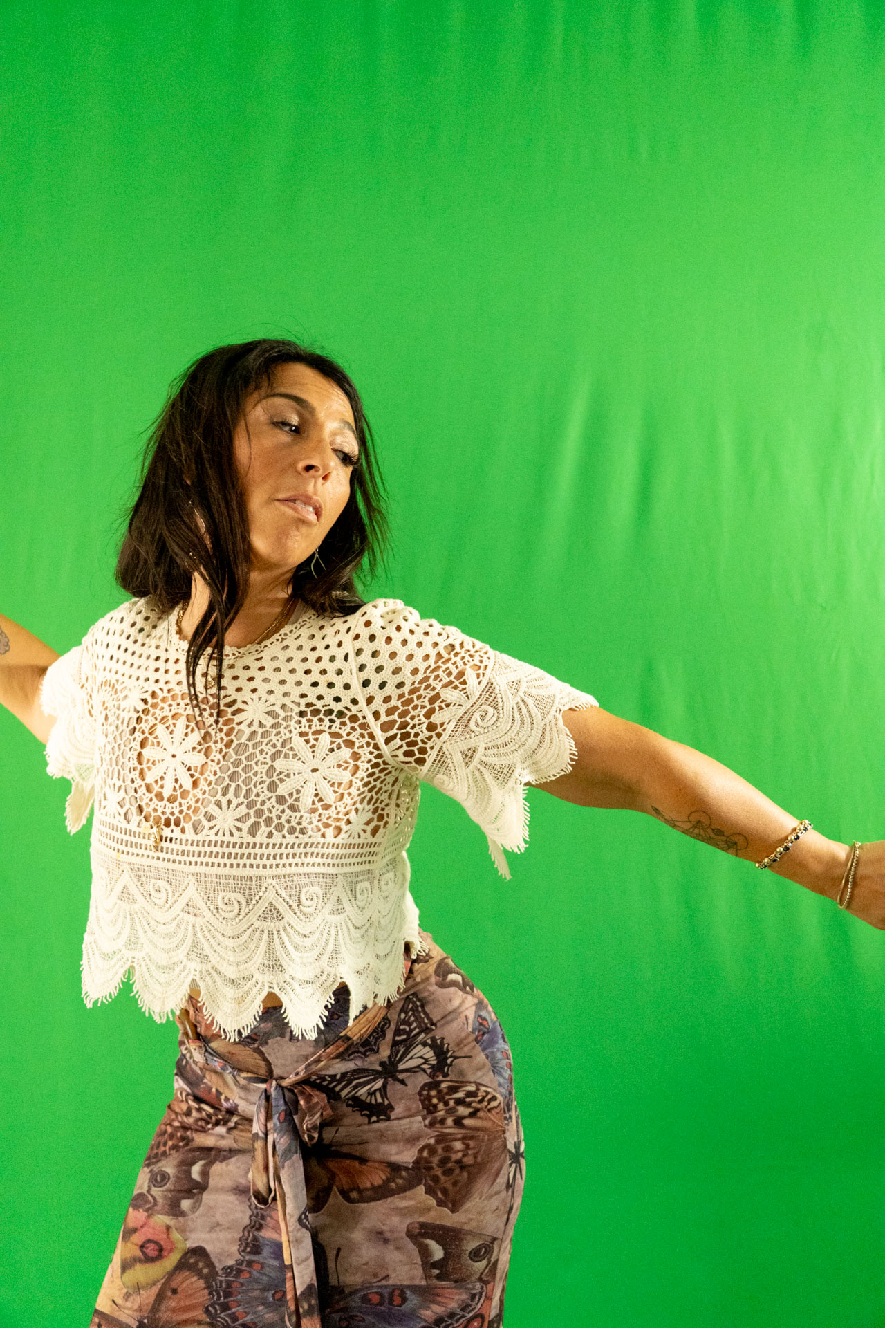 energetic medicine woman Audrey Love dancing, green backdrop