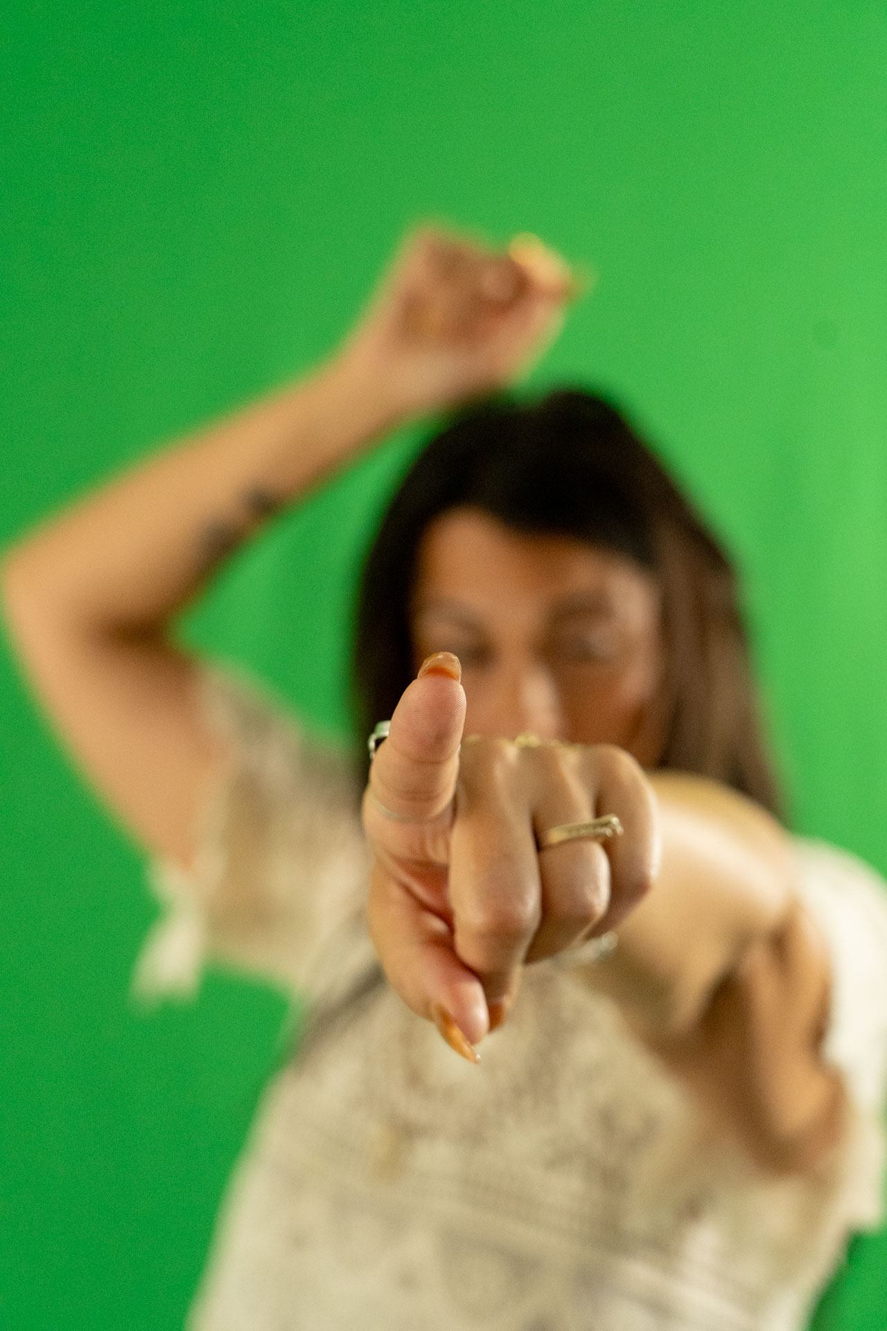 energetic medicine woman Audrey Love performing light language, green backdrop
