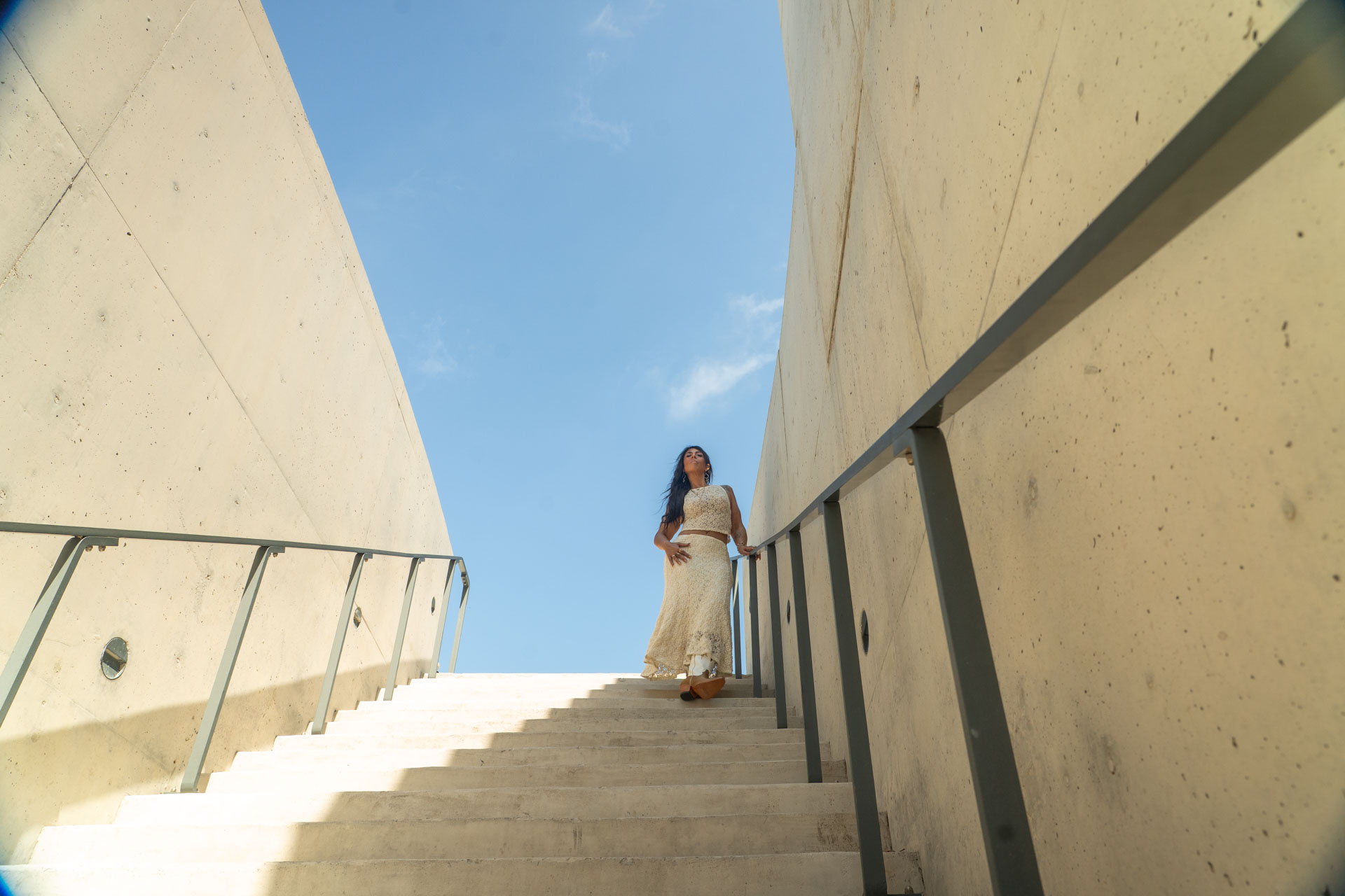 energetic medicine woman Audrey Love standing atop a staircase
