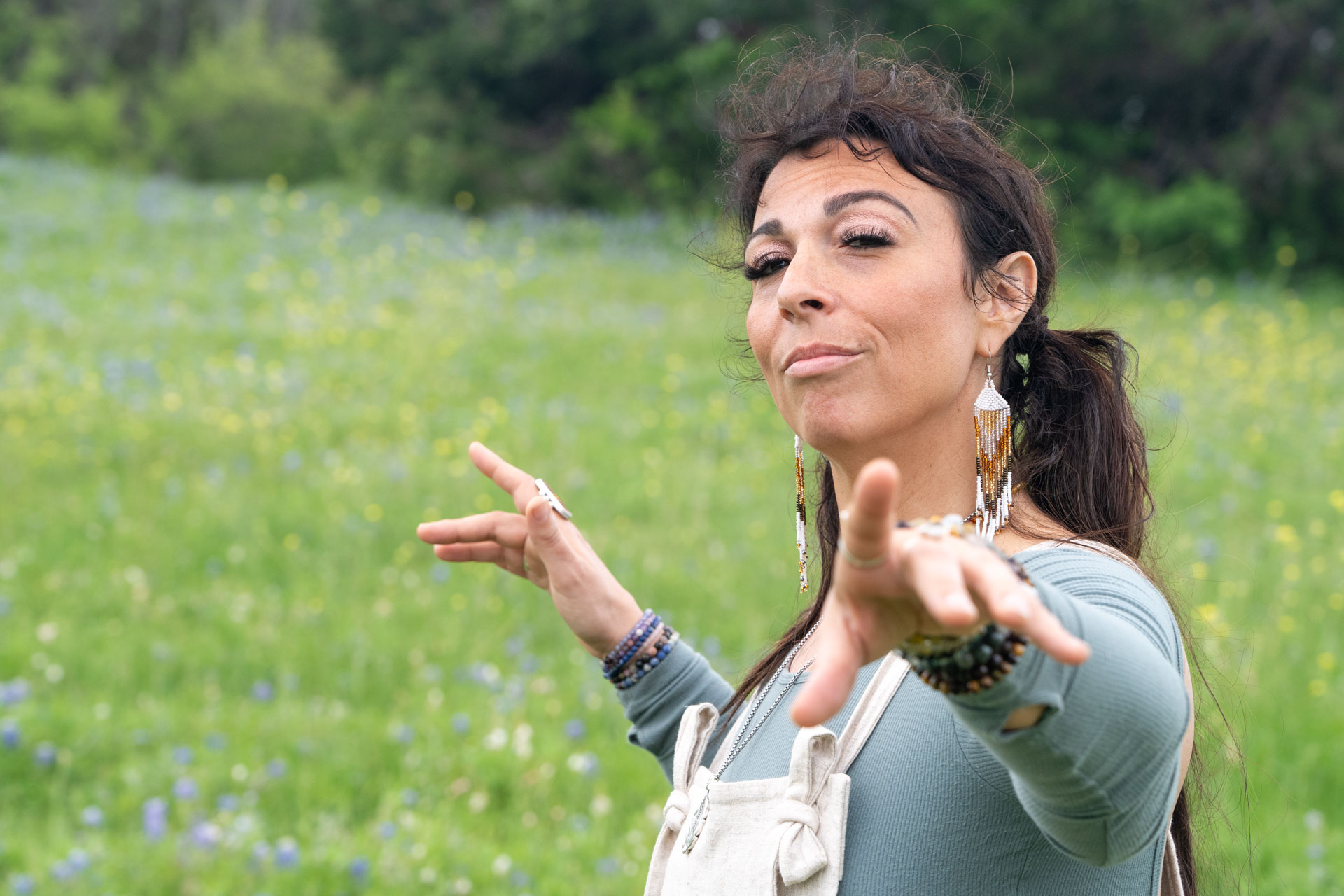 energetic medicine woman Audrey Love performing light language in a field of bluebonnets in Austin, Texas